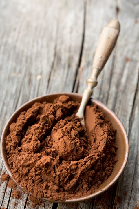 close up cocoa powder in bowl on table
