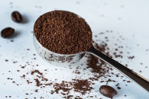 close up of ground coffee in scoop on table