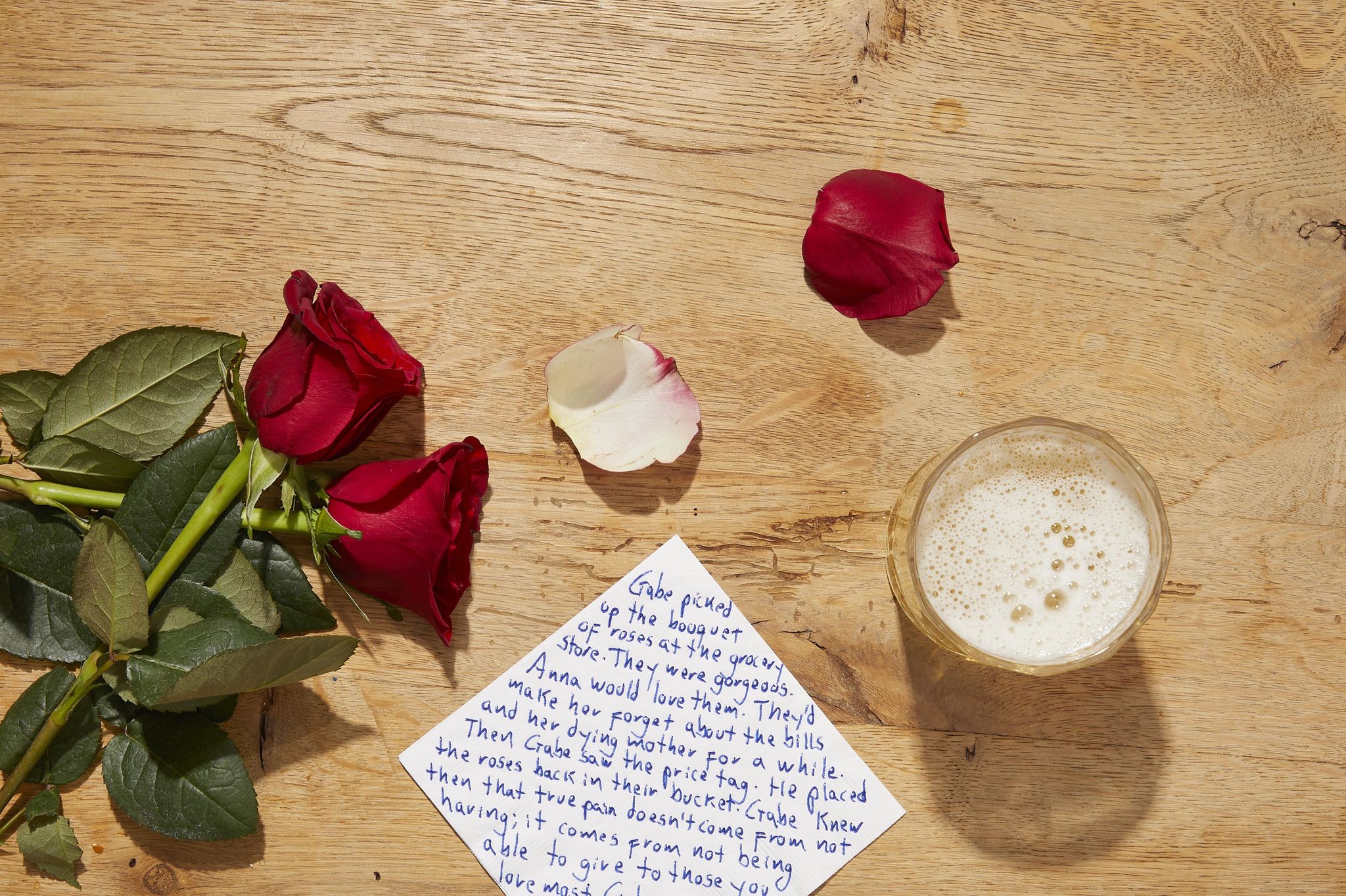 a note and flowers on a table