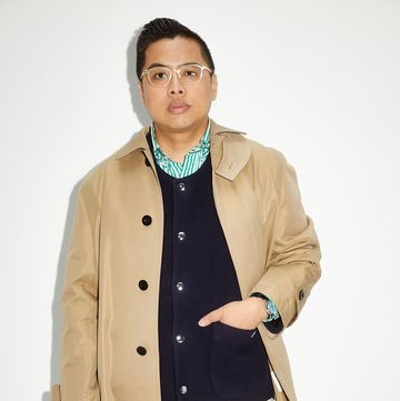 a man wearing a coat and glasses