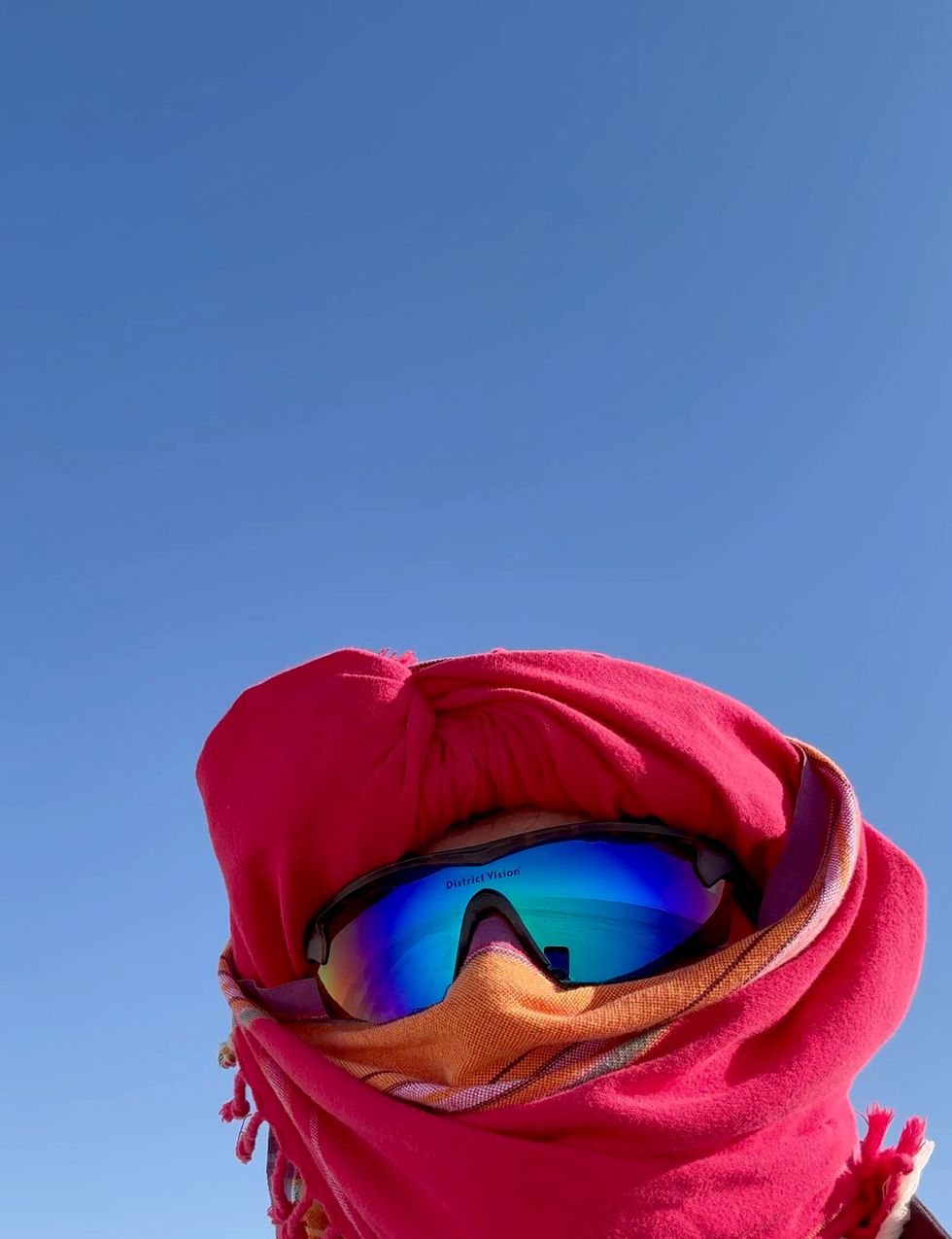 a person wearing a red hat and sunglasses
