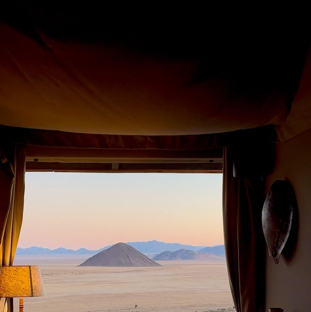 a bedroom with a view of the mountains and the ocean