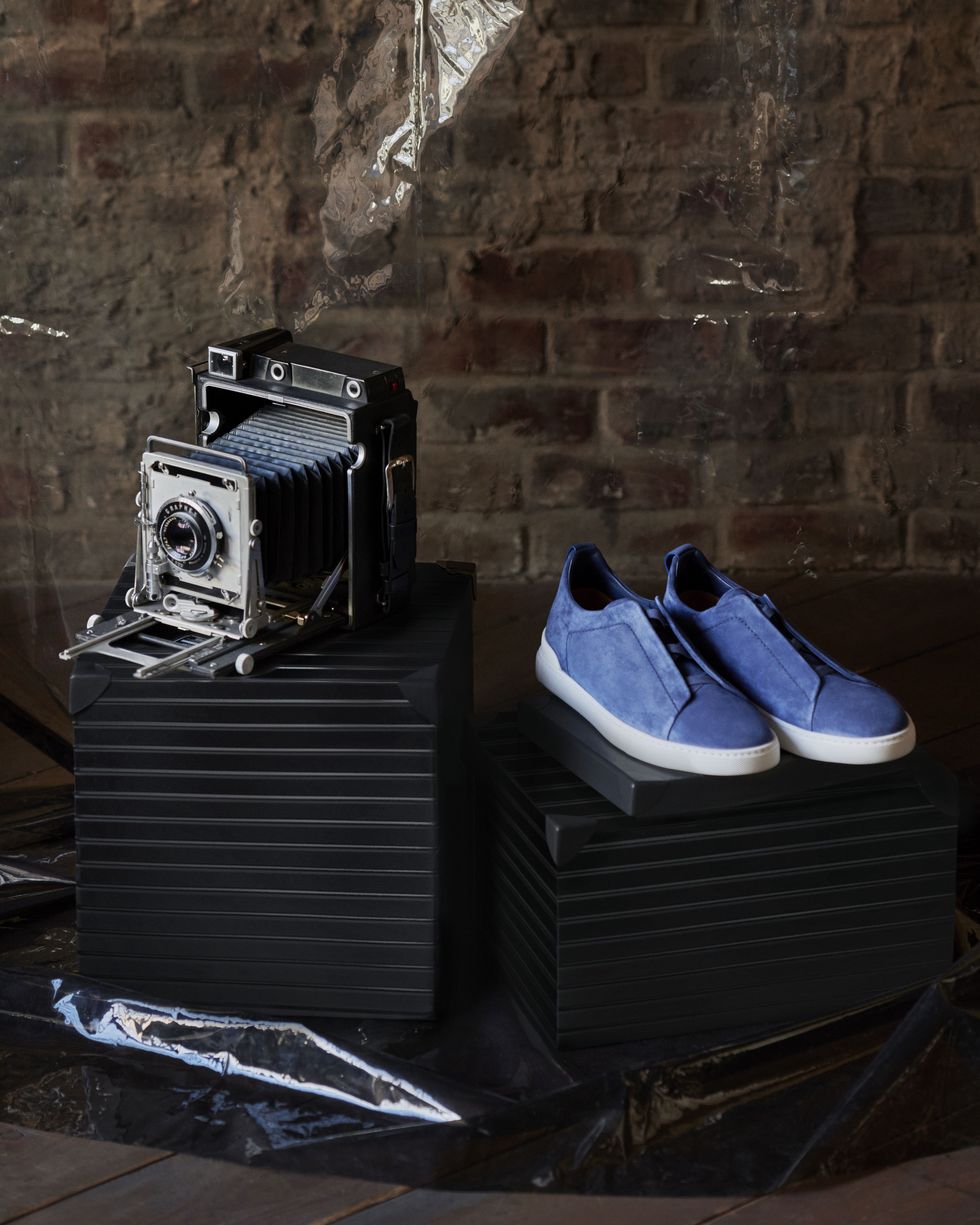 still life of camera and sneakers