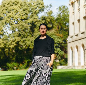 rossella menegazzo professor university milan standing in a grassy area with trees and a building in the background