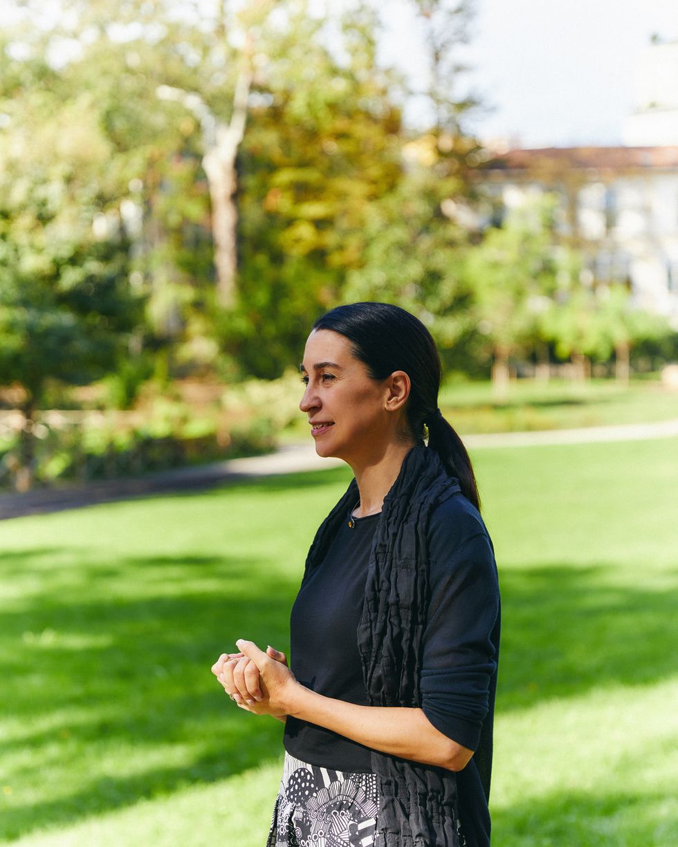 rossella menegazzo professor university milan standing in a grassy area with trees and a building in the background