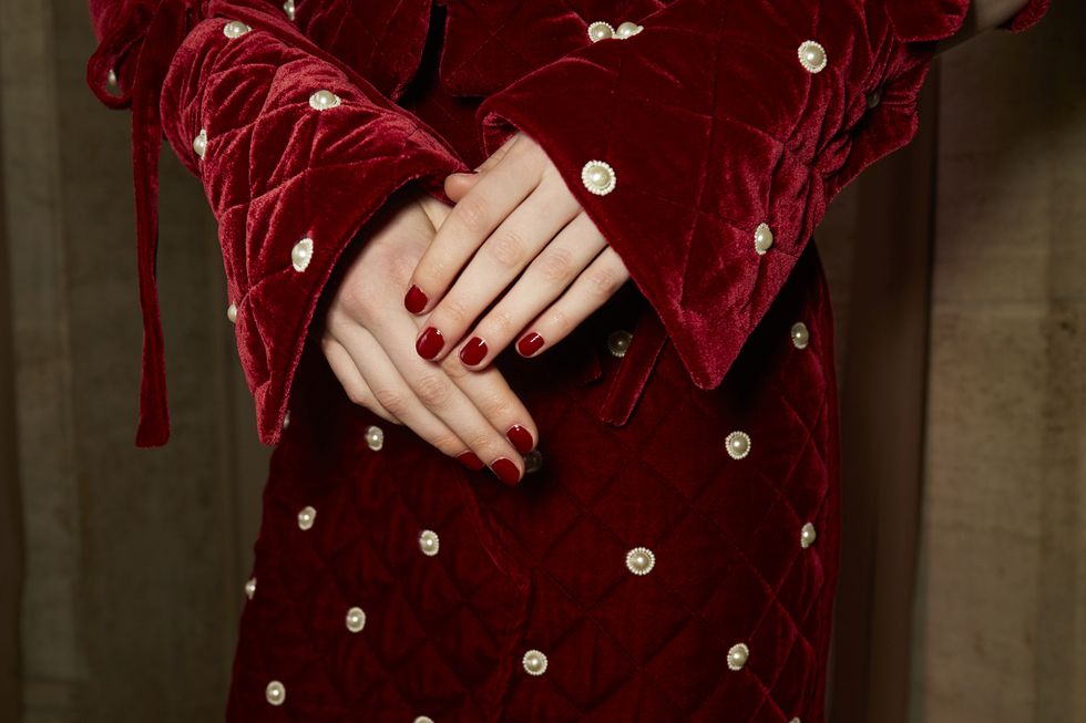 Red, Maroon, Outerwear, Hand, Pattern, Design, Human body, Sleeve, Textile, Dress, 