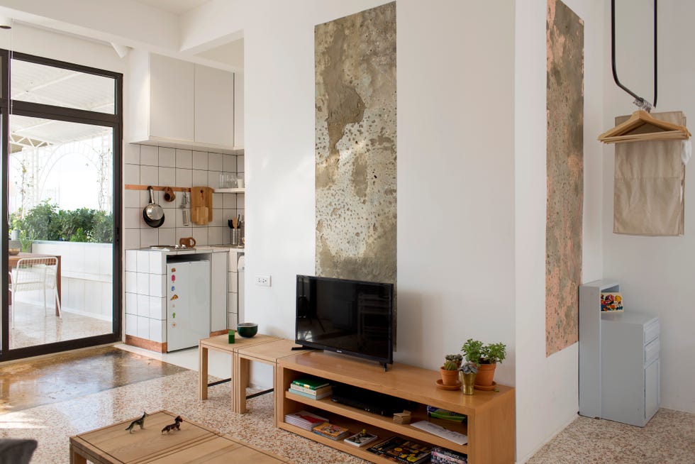estudio de diseño moderno con salón, cocina, comedor y dormitorio en un mismo ambiente
