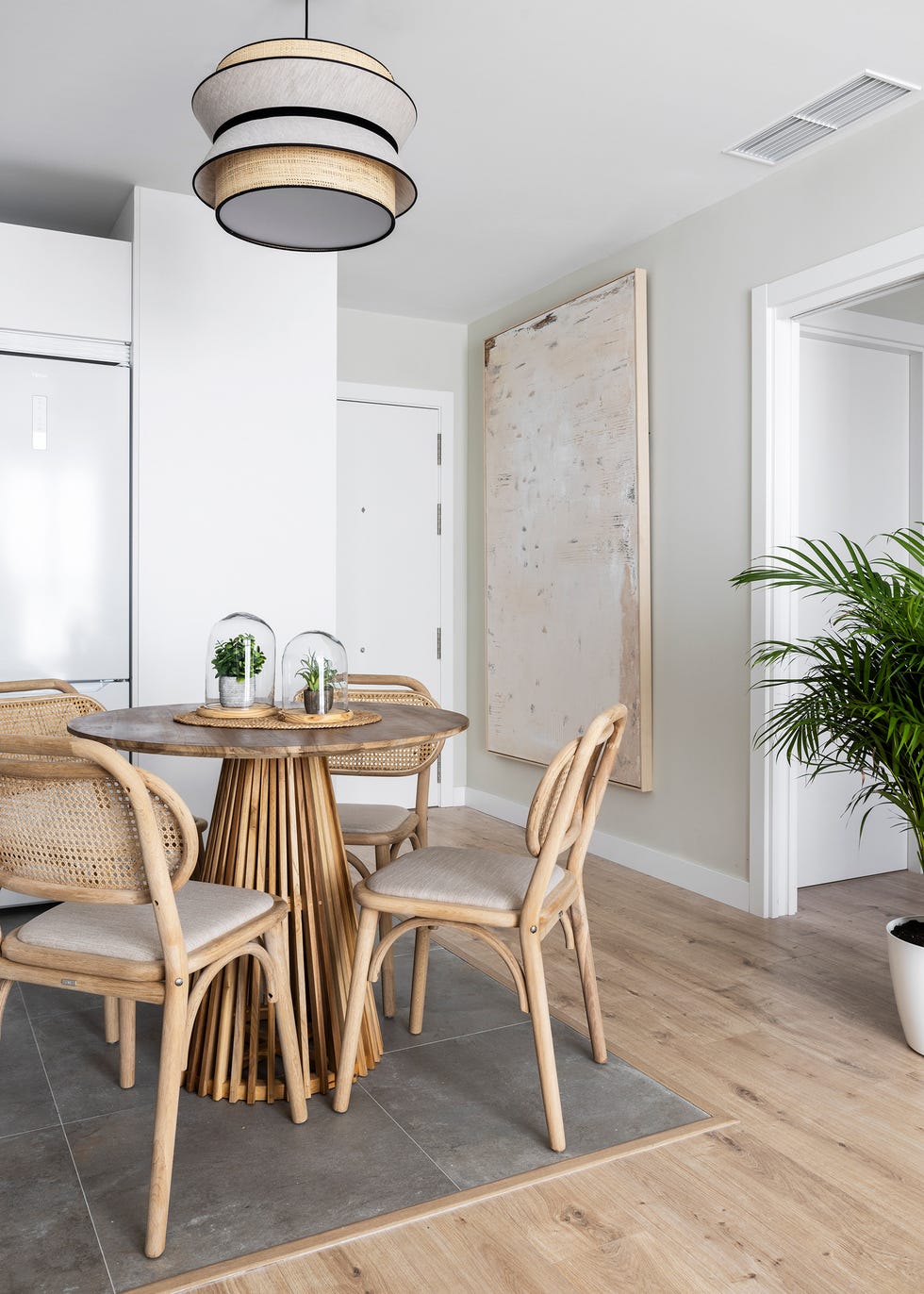 cocina abierta con mesa de comedor redonda y sillas de madera