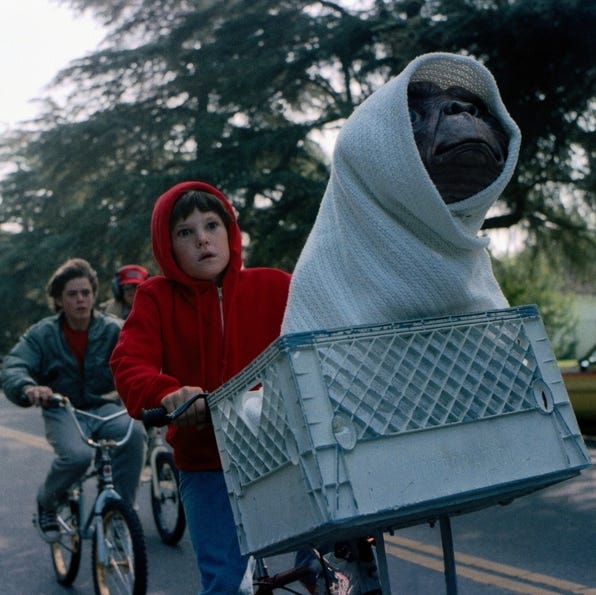 elliot and et take off on their bikes in a scene from et the extra terrestrial a good housekeeping pick for best halloween movies for kids