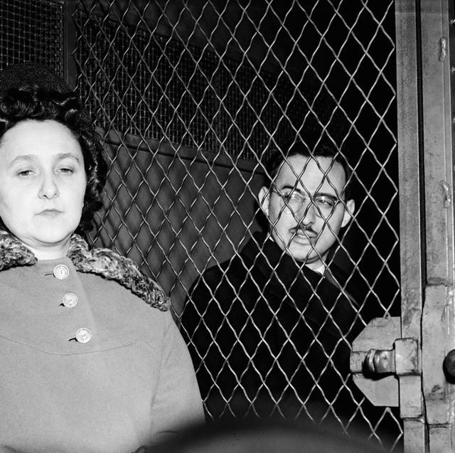 ethel and julius rosenberg sit in a police van with a fence in between them