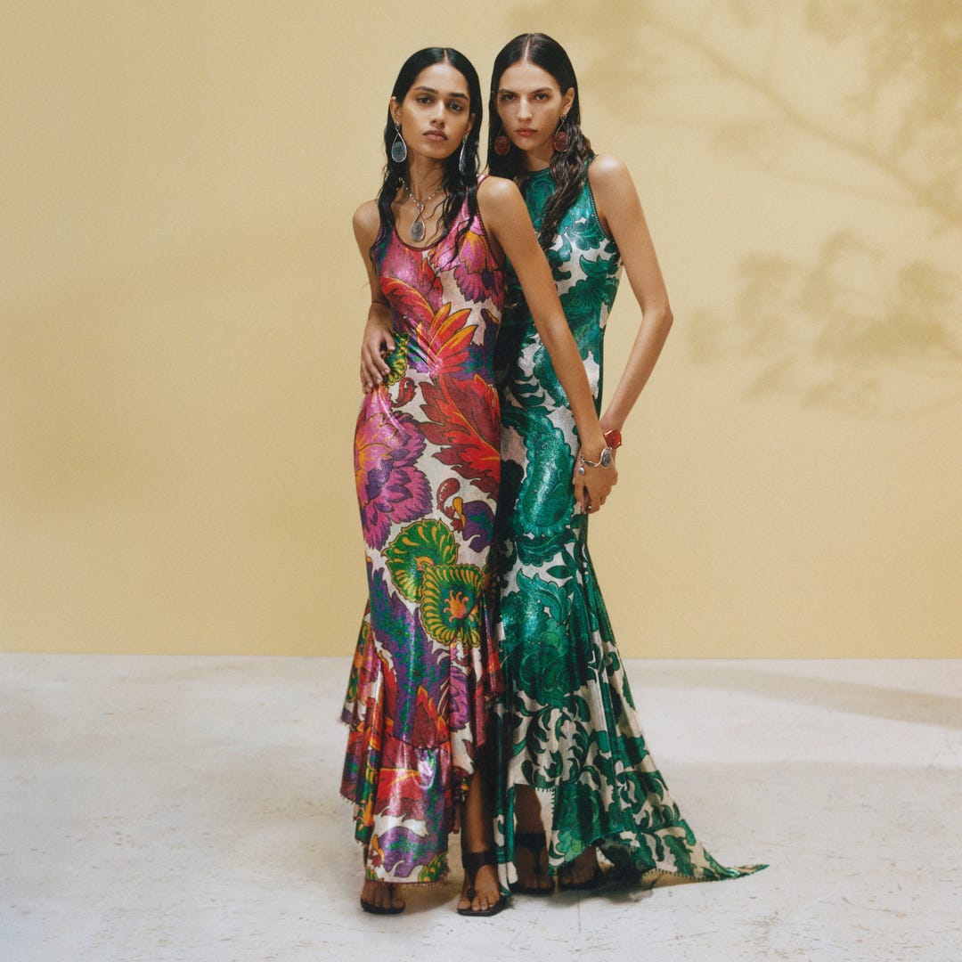 two models standing together in colorful dresses