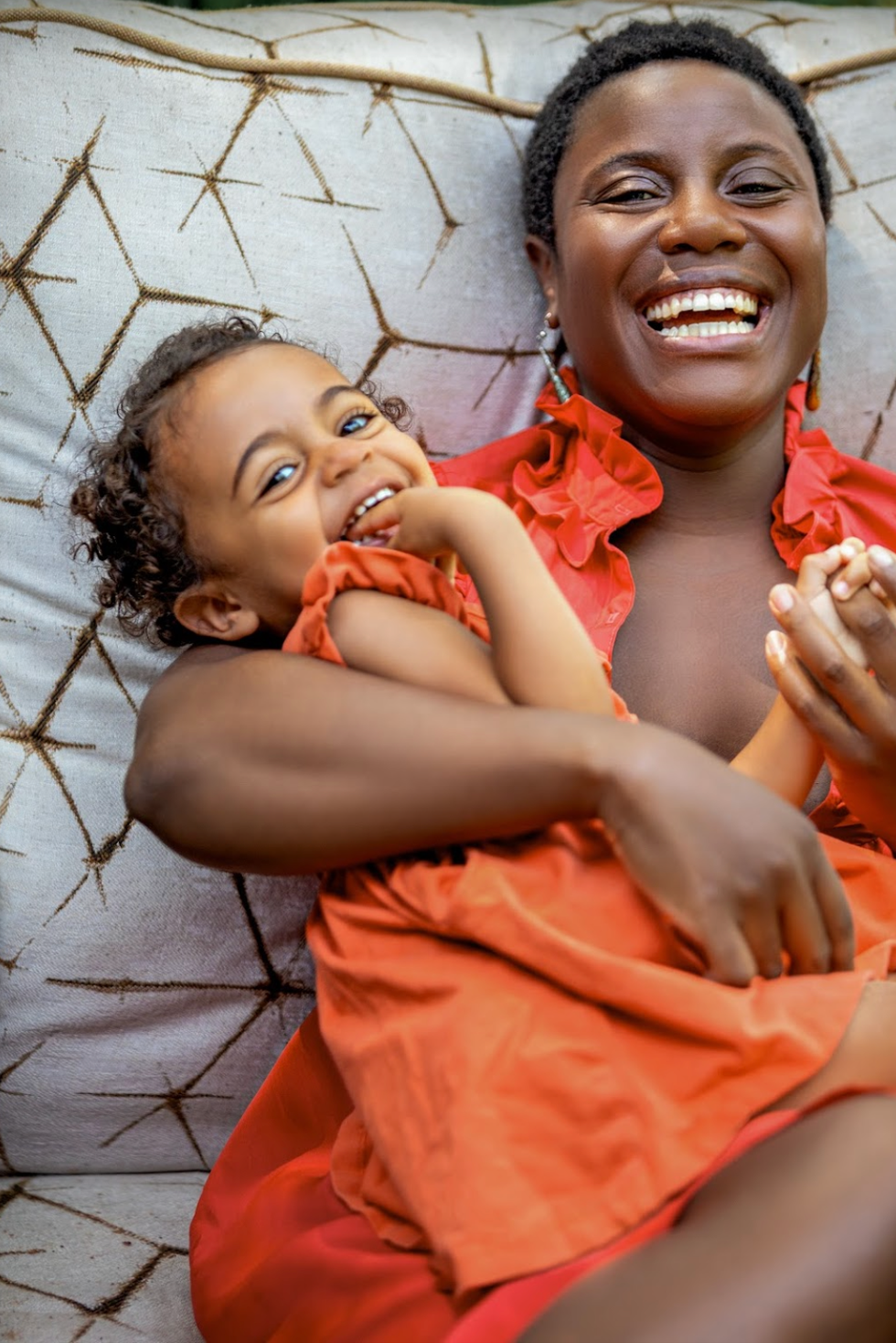 eu'genia shea butter shop small interview, woman with her small daughter wearing orange
