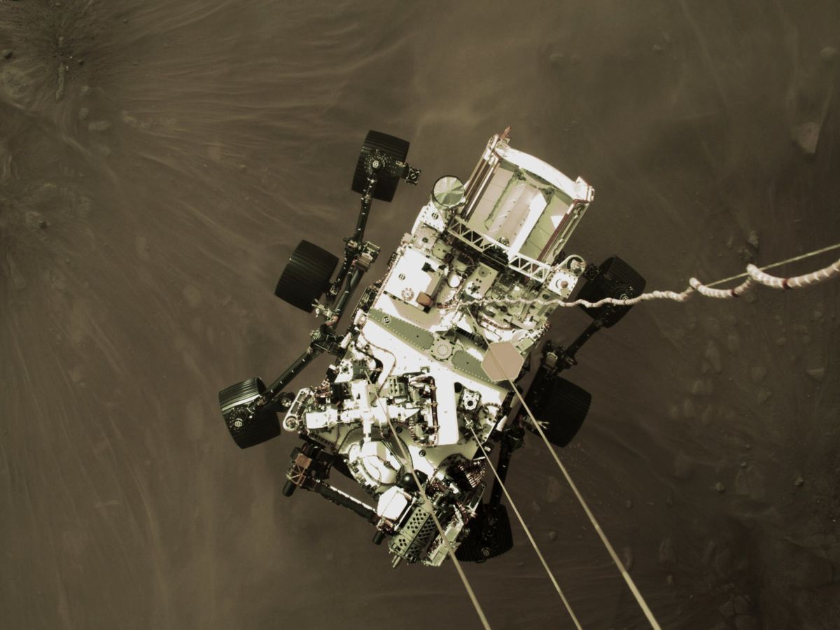 nasa's perseverance rover is lowered toward surface of mars by the descent stage