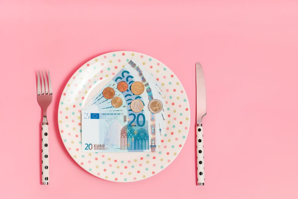 euro banknotes and coins on a polka dots pattern plate
