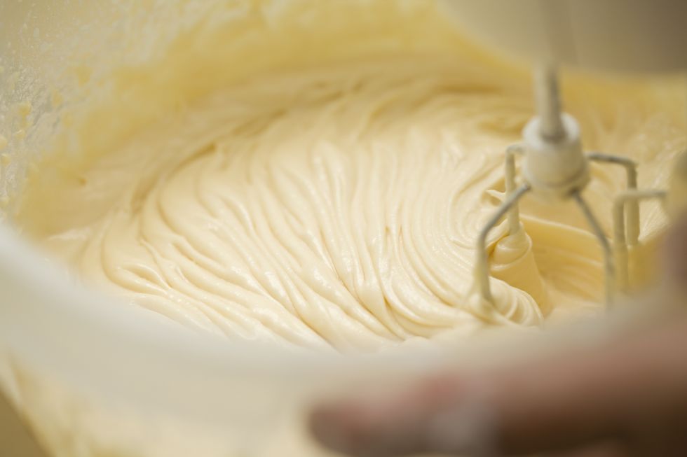 Europe, Germany, North Rhine Westphalia, Human hand mixing batter with wire whisk, close up
