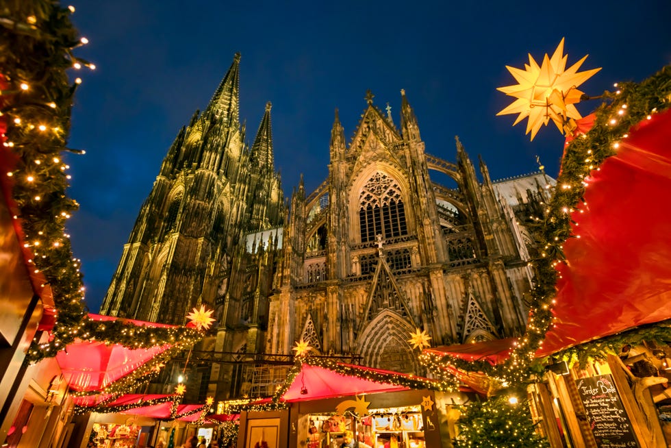 cologne christmas market with cologne cathedral at dusk cologne, north rhine westphalia, germany