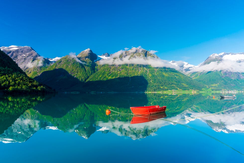 boats moored in the clear water of Lake Oppstrynsvatn, Hjelle, Oppstryn, Sogn og Fjordane County, Norway