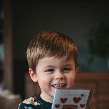 a boy holding a toy