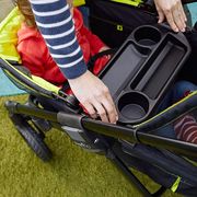 parent adjusting cup holder in evenflo wagon stroller