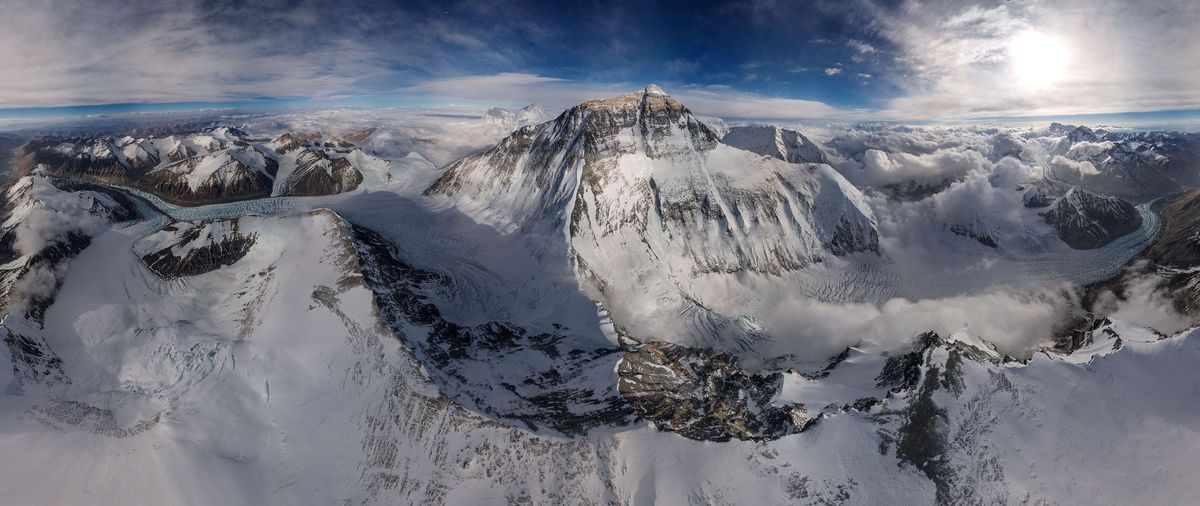 Op deze mozaekfoto die bestaat uit 26 opnamen die als puzzelstukjes in elkaar passen is de noordzijde van de Mount Everest te zien inclusief omgeving Als de linker en rechterkant van deze foto tegen elkaar worden gelegd ontstaat een doorlopend panoramabeeld van 360 graden