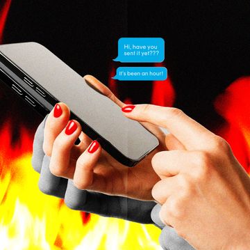a person holding a phone with flames in the background