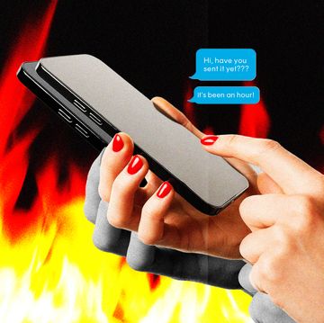 a person holding a phone with flames in the background