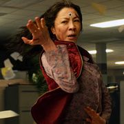 michelle yeoh goes into fighting stance in an irs office in the film everything everywhere all at once