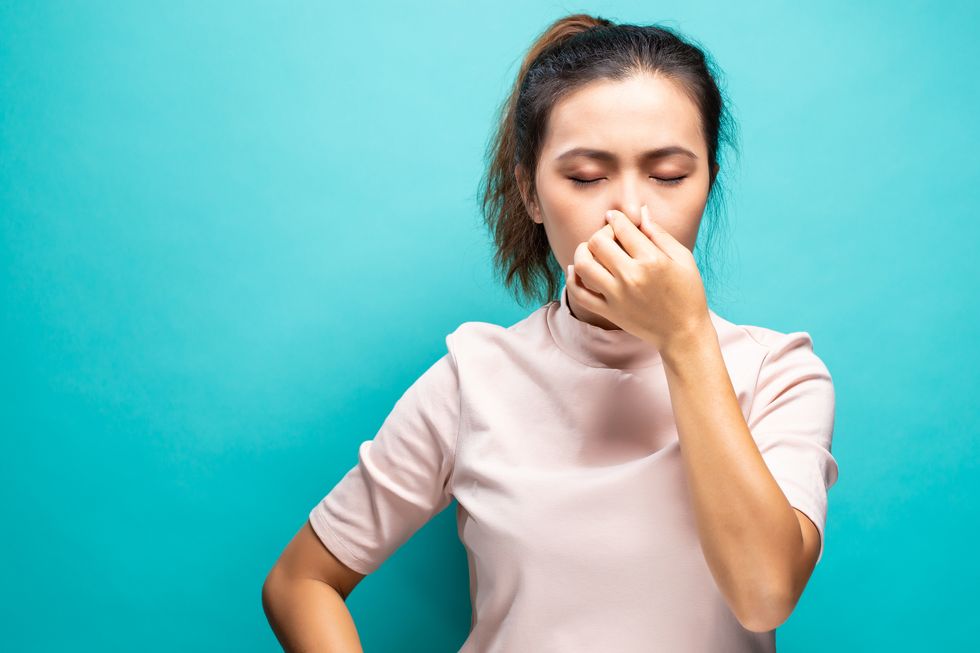 Woman Suffering From Cold And Flu Against Turquoise Background