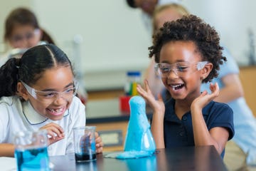 excited schoolgirls enjoy science experiment