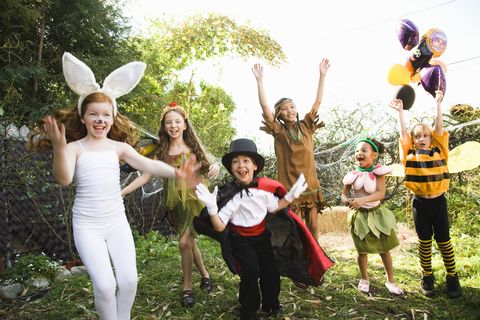Excited children in Halloween costumes