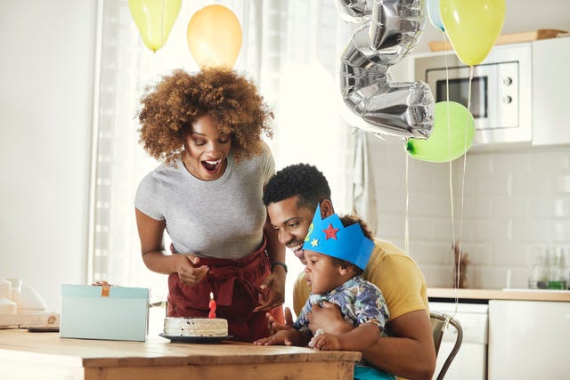 excited parents celebrating birthday with son