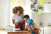 excited parents celebrating birthday with son