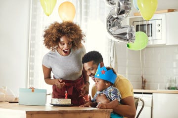 excited parents celebrating birthday with son