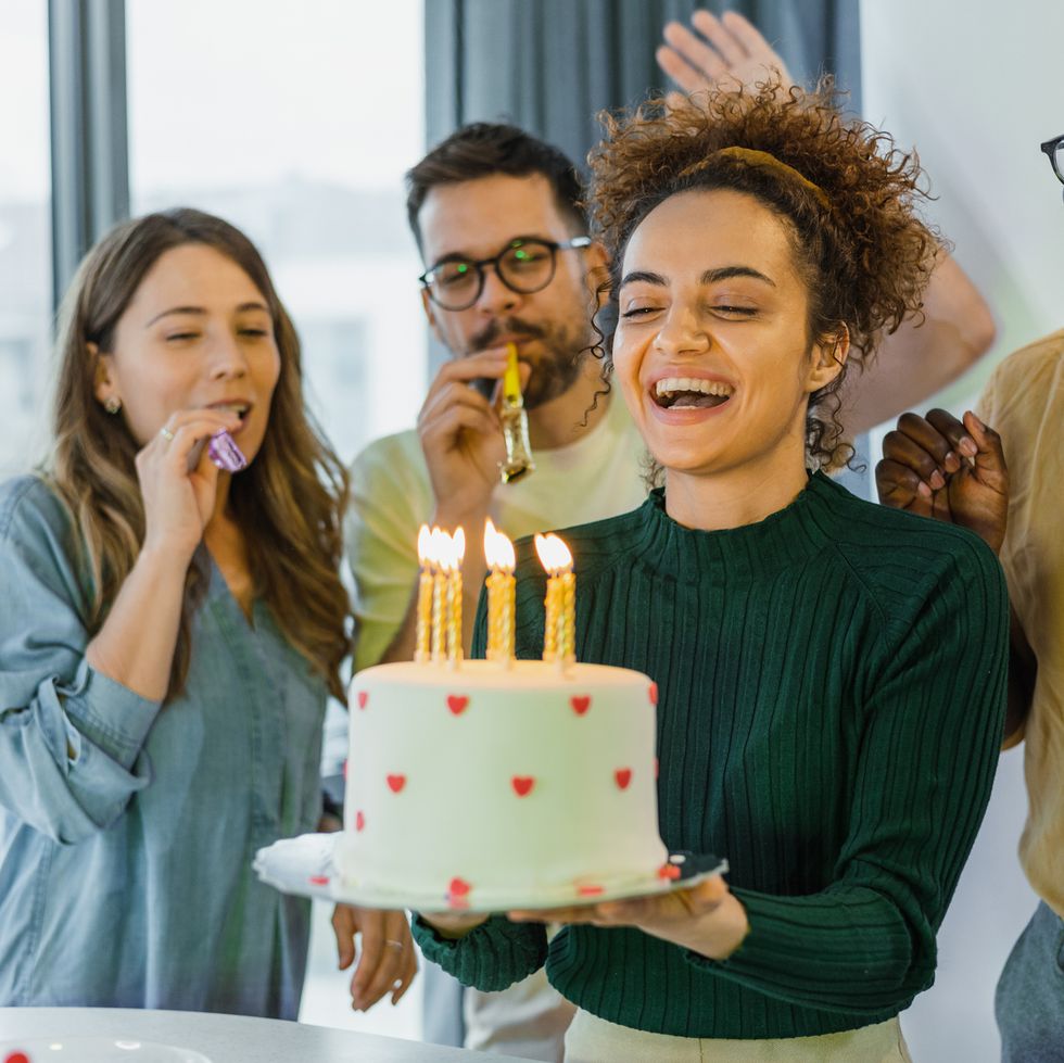 excited young woman ready to blow out candles