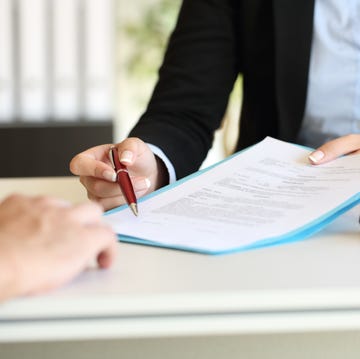 Executive hands indicating where to sign contract Executive hands indicating where to sign contract