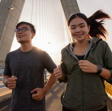 Exercise by running in the morning together on walking path at the Suspension bridge in the city. exercise by running in the morning together on walking path at the suspension bridge in the city