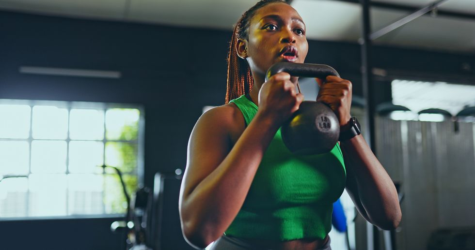 exercise, kettlebell and black woman in gym, for fitness and workout for wellness, health and training healthy girl, african american female and athlete with equipment for practice, cardio or strong