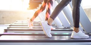 Exercise treadmill cardio running workout at fitness gym of woman taking weight loss with machine aerobic for slim and firm healthy in the morning.Show of running shoes, rubber floor, softness,