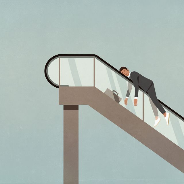 exhausted businessman on ascending escalator