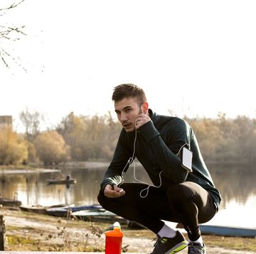 exhausted runner resting near lake
