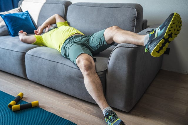 exhausting home training tired man resting on sofa after the morning workout