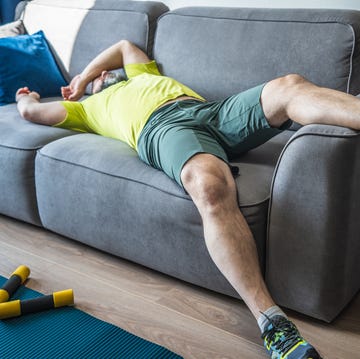 Exhausting home training. Tired man resting on sofa after the morning workout exhausting home training tired man resting on sofa after the morning workout