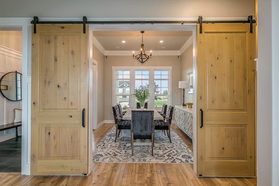 room divider ideas with a dining room with double barn door entrance