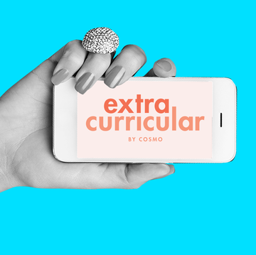 logo for extracurricular by cosmo on cell phone screen held by hand against blue background