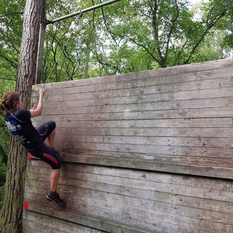 a person climbing a wooden fence