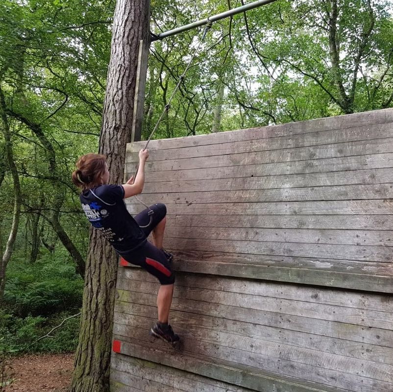 a person climbing a wooden fence