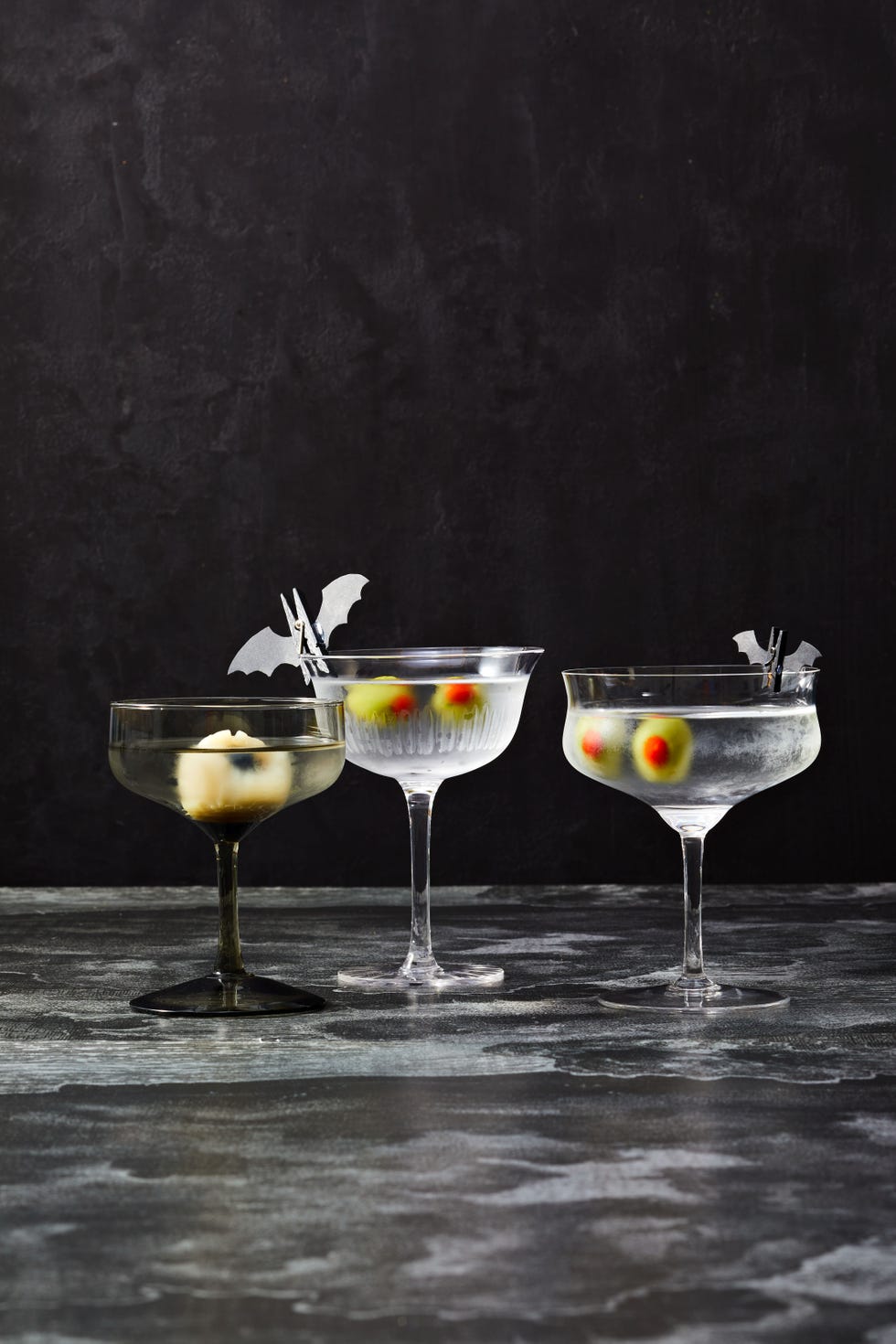martini glasses with stuffed olives and lychee that look like eyeballs for halloween