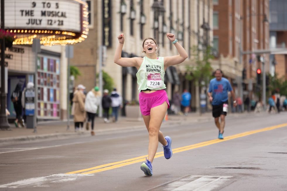 runner celebrating during a race in an urban setting grandmas marathon