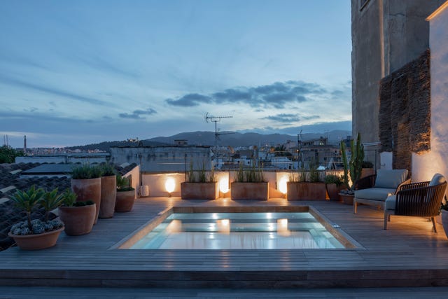 Rooftop terrace with a small pool and seating area