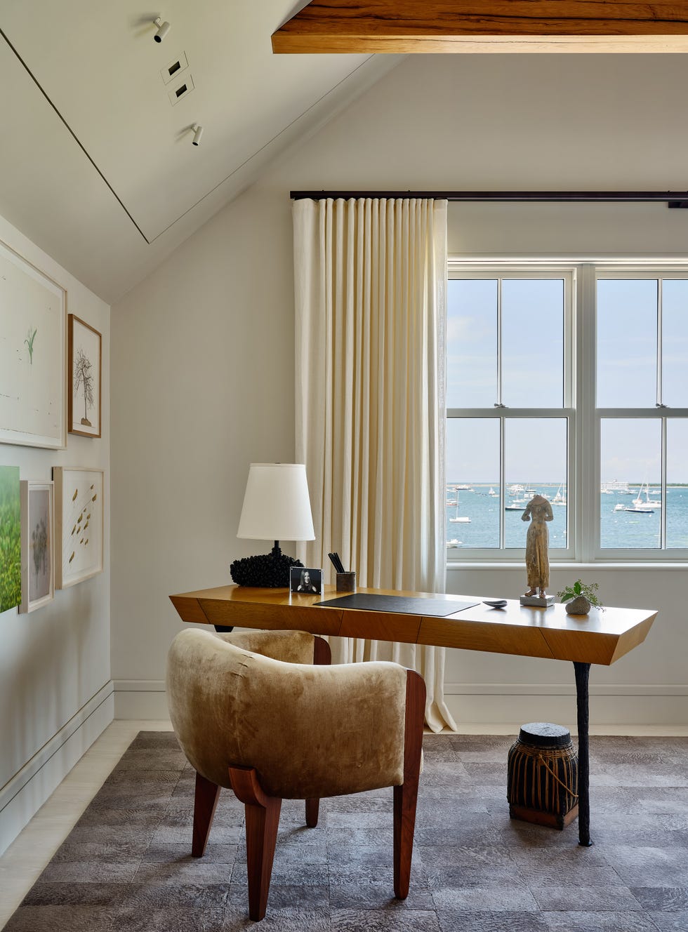 Cozy workspace with a desk  chair  and view of the water